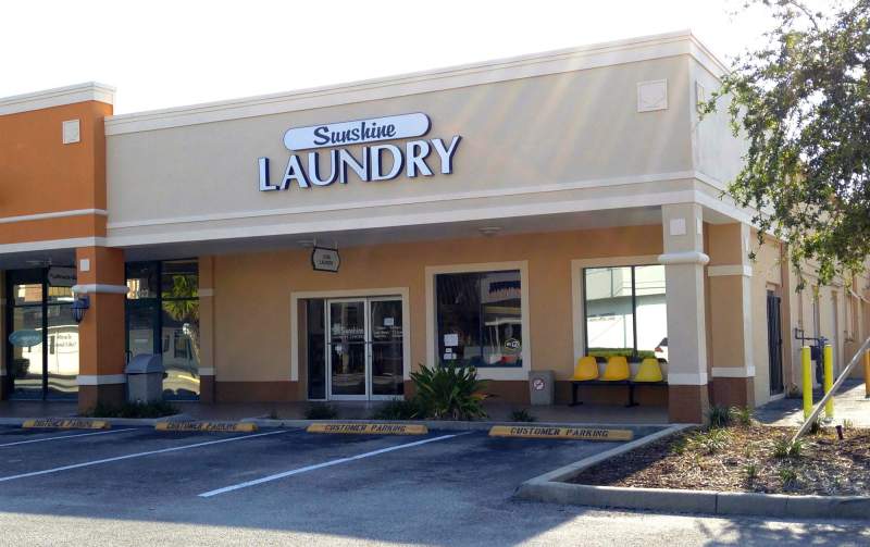 Miracle Mile Sunshine Laundry Exterior with parking lot.