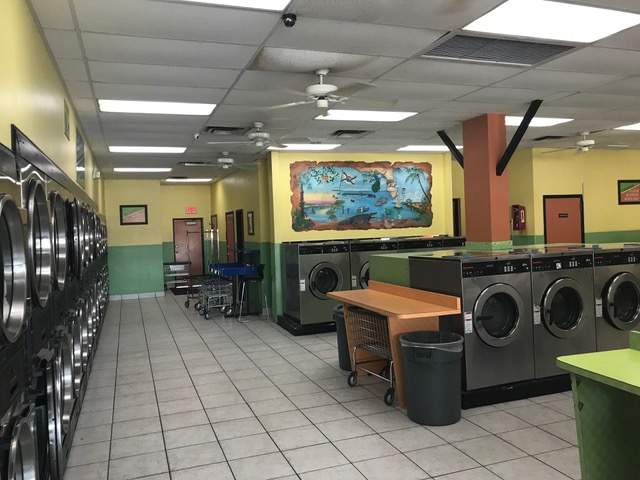 South U.S. 1. Row of washers and dryers. Counter space. Yellow and green interior.